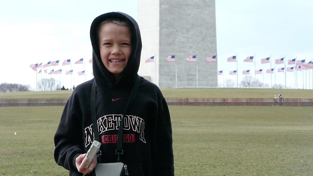 Benji Backer as a kid, standing in front of the Washington Monument